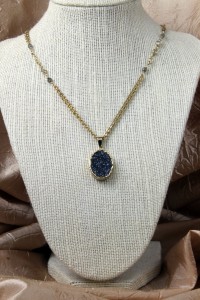 Cobalt drusy pendant on gold necklace