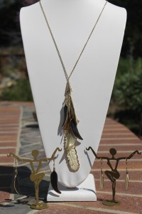 Feather pendants on long gold necklace