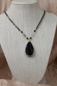 Large faceted teardrop onyx pendant on gold necklace