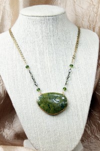 Large green turquoise pendant on gold necklace