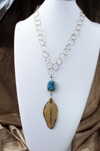 Turquoise and gold leaf pendant on long gold chain